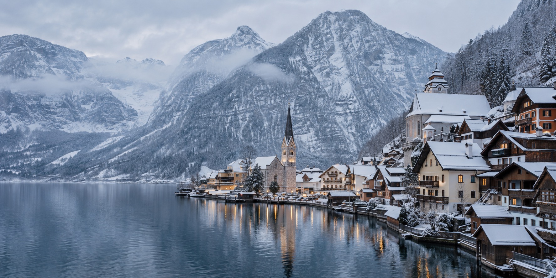 Hallstatt village lakefront dusted with snow in winter, quiet and empty of crowds